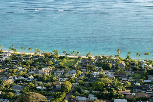 The sunrise lights up the high-end homes of the Lanikai neighborhood. This is the view from Lanikai Pillbox trail.