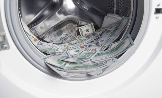 istock Hundred dollars in a washing machine. 1301145650