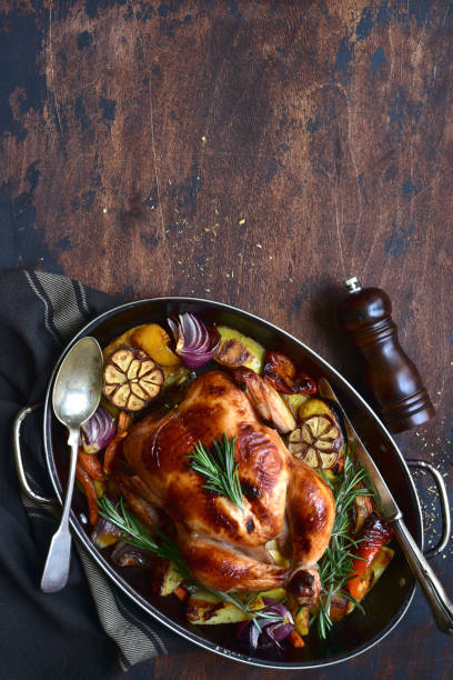 istock Oven baked chicken with roasted vegetables in a skillet pan 1301146484