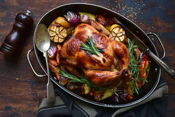 istock Oven baked chicken with roasted vegetables in a skillet pan 1301146499