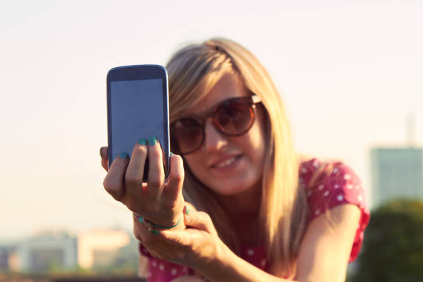 istock Young woman using modern smartphone outdoors. 1301148119