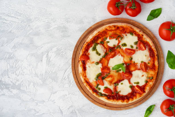 istock Top view of pizza Margherita on gray surface 1301148523