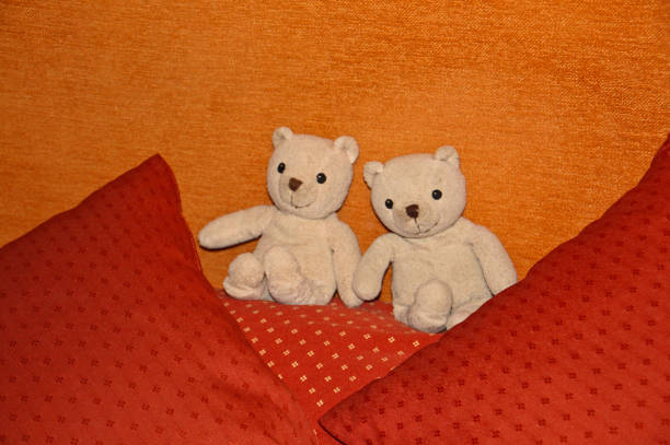 istock Two stuffed bears sitting on the bed 1301151618