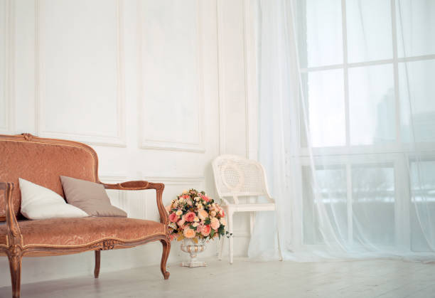 istock luxury clean bright white interior. a spacious room with sunlight and flowers in vases 1301151734