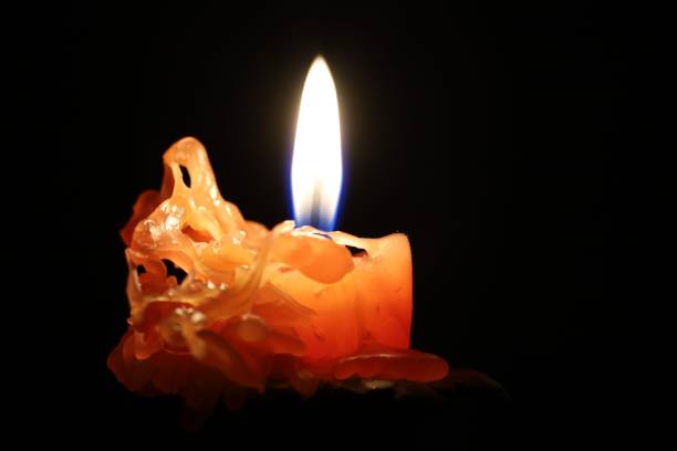istock Burning candle in the dark close-up 1301151844
