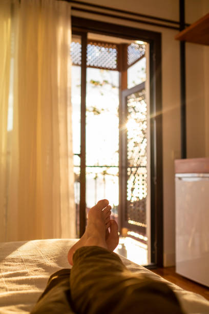 istock lying and relaxing in bed opposite a window at sunset 1301153322