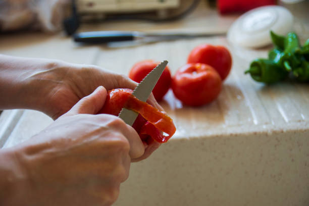 istock woman is peeling fresh tomato with knife 1301153740