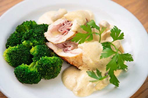 Cordon bleu with broccoli and melting cheese, chicken white meat rolled up and stuffed with ham and cheese