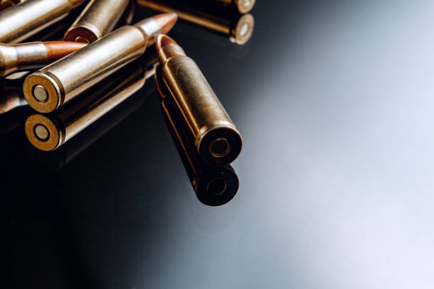 istock Rifle bullets or cartridges on black shiny background 1301154060