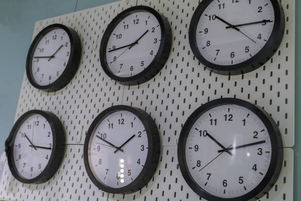 istock black and white 6 simple clocks on white wall. Time concept, time management 1301158969
