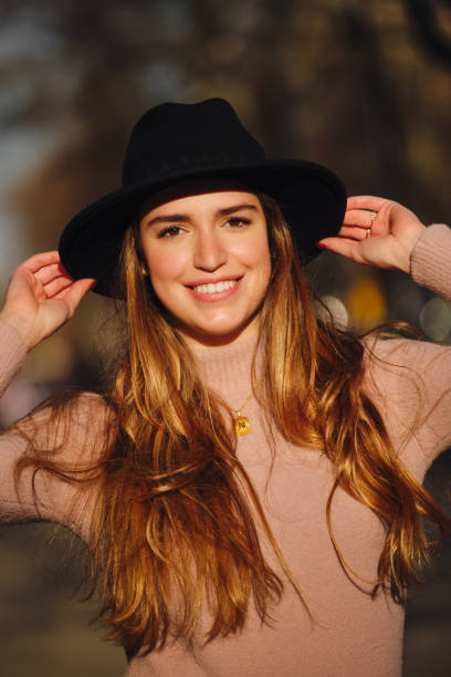 istock Woman smiling while standing outdoors. 1301160911