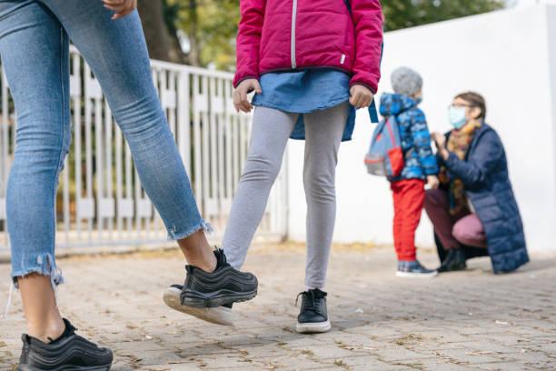 istock Kids greeting with foot bump 1301160945