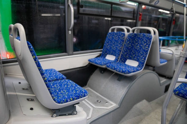 istock Empty bus interior. Blue seats without passengers. Public transport. Transportation of passengers by public transport. Ergonomic interior of the bus. Travel to other cities. 1301162873
