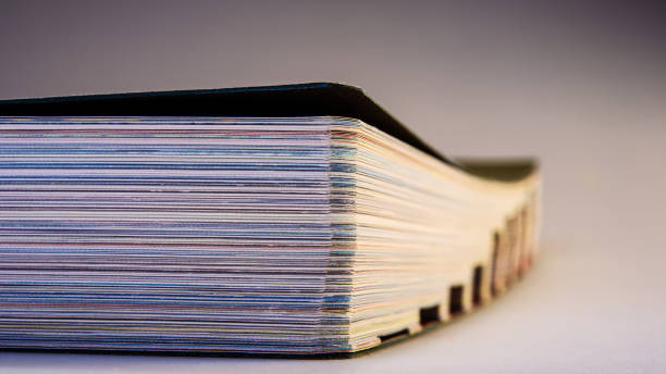 istock closed paperback book lies on a light blurred background. 1301163405