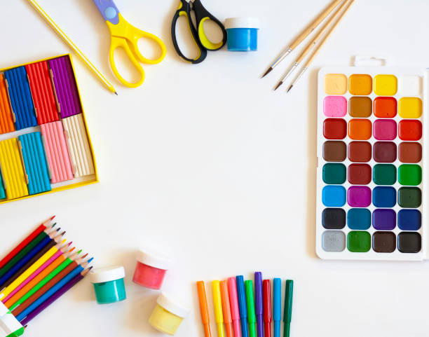 istock Stationery for school and creative work on a white background, paints, pencils, markers, plasticine and scissors, flat lay, copy space 1301164492