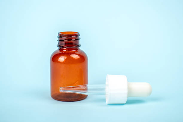 istock Cosmetic bottle isolated on blue background. Mock up container for design. Medical and cosmetics concept. 1301167409