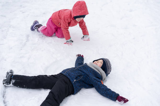 istock Little children playing with snow. 1301167441
