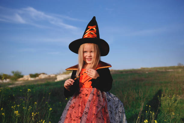 istock little girl dressed as a witch celebrates halloween 1301168224