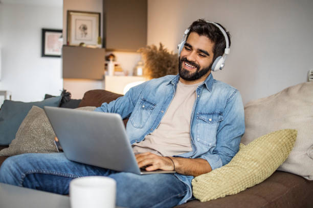 istock Photo of a man using laptop and relaxing 1301168811