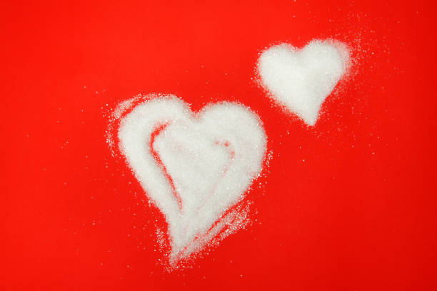 istock Sugar hearts shaped scrub isolated on red background 1301169792
