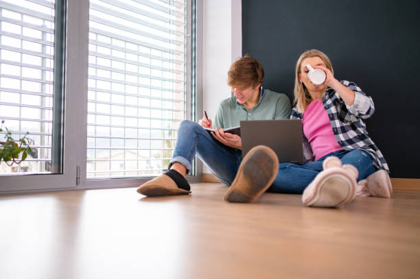 istock Young couple using laptop on the floor 1301169825