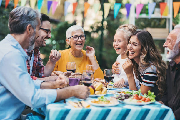 istock Happy family eating and drinking in the back yard 1301171040