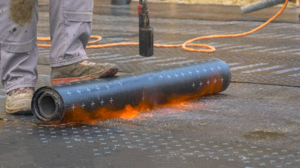 istock CLOSE UP: Contractor lays roll of bitumen on ground and burns it with blowtorch. 1301171108