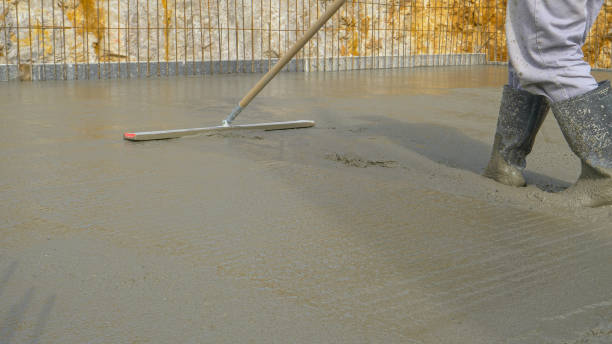 istock LOW ANGLE: Unrecognizable worker uses a leveling tool to spread the wet concrete 1301171231