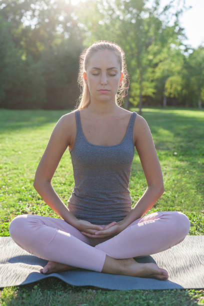 istock Beautiful Young Woman Meditating 1301172625