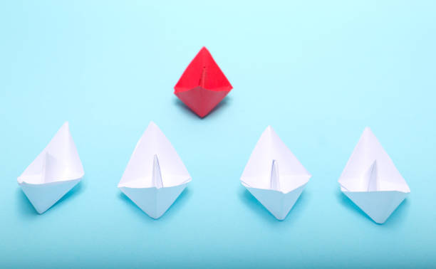 istock Business competition concept with paper ships on white background 1301172731