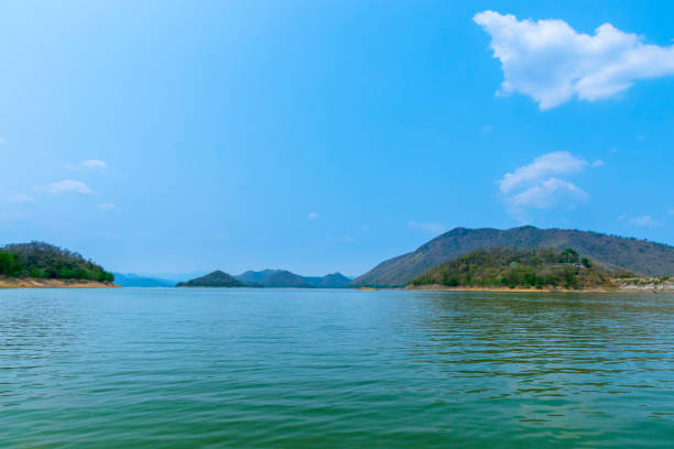 istock The lake scenery with mountains behind under the blue sky 1301173377