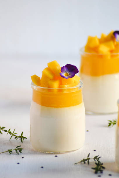 istock Panna cotta with mango jelly and pieces of fresh mango on white background. 1301173790