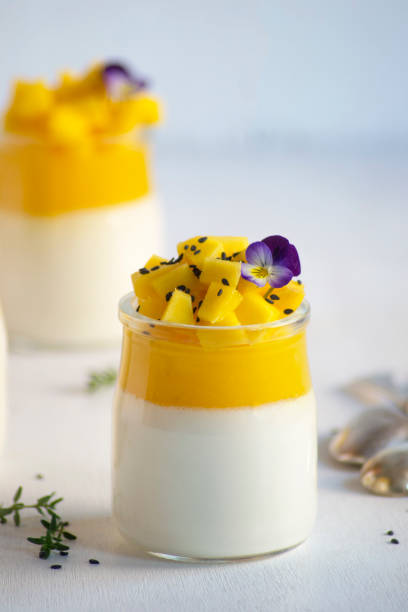 istock Panna cotta with mango jelly and pieces of fresh mango on white background. 1301174512