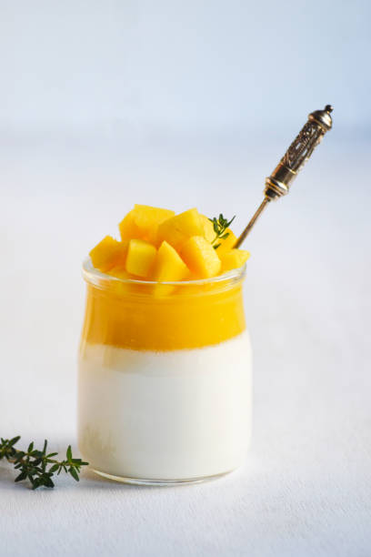 istock Panna cotta with mango jelly and pieces of fresh mango on white background. 1301175307