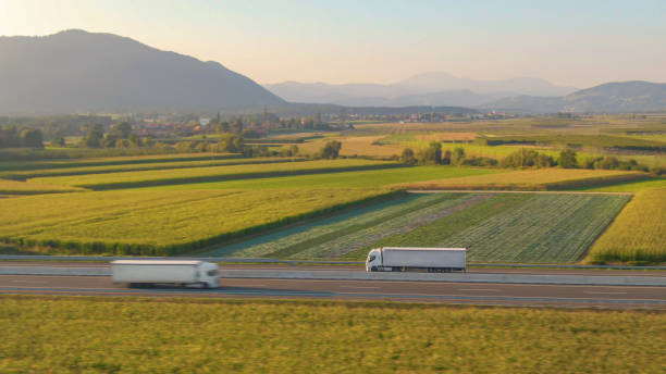 istock AERIAL: Flying along a white semi truck hauling freight down a scenic highway. 1301175549