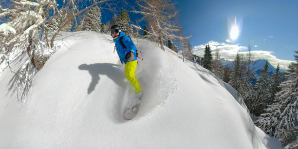 selfie, lens flare: extreme winter athlete goes tree snowboarding on a sunny day - mountain bluebird imagens e fotografias de stock