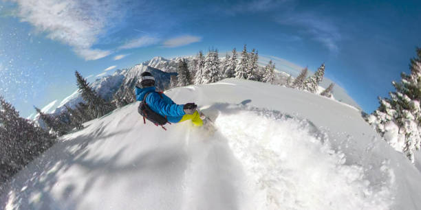 selfie: snowboarder is carving fresh powder snow while riding through a forest - mountain bluebird imagens e fotografias de stock