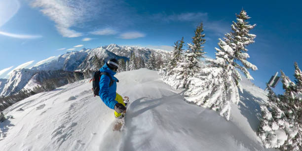 selfie: male snowboarder cruises through a forest covered in fresh powder snow. - mountain bluebird imagens e fotografias de stock