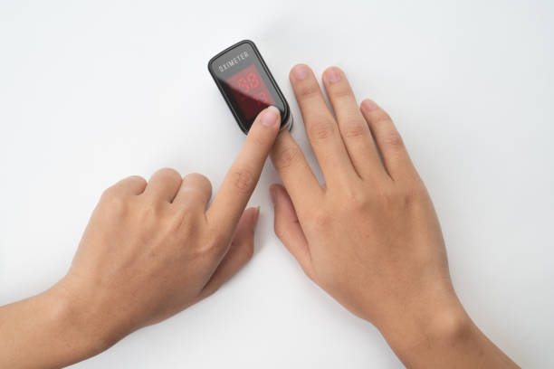 istock Hand measuring oxygen saturation with pulse oximeter 1301176685