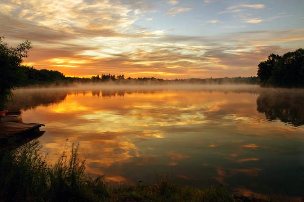 istock Golden sunrise above pond, peaceful. 1301178589