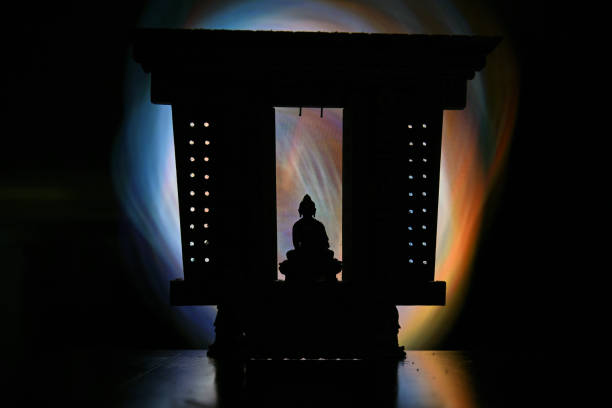 istock Buddha figurine in colorful halo 1301178919