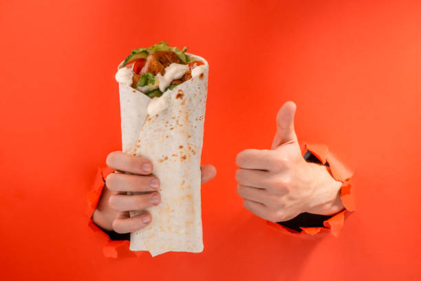 istock Hand holding a doner and showing a thumb up 1301179254