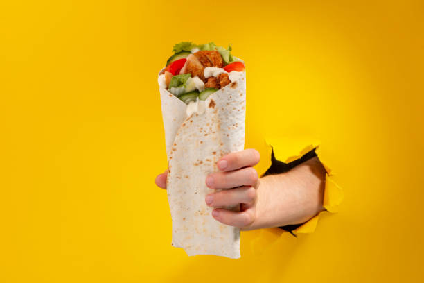 istock Hand giving a fresh doner roll. Delicious Turkish dish 1301179872