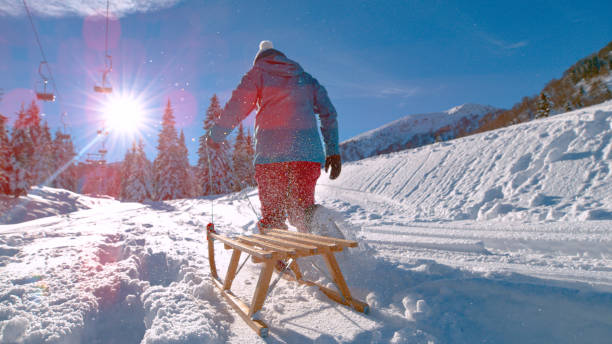 istock LOW ANGLE: Unrecognizable woman on sleighing trip explores the empty ski resort. 1301180201