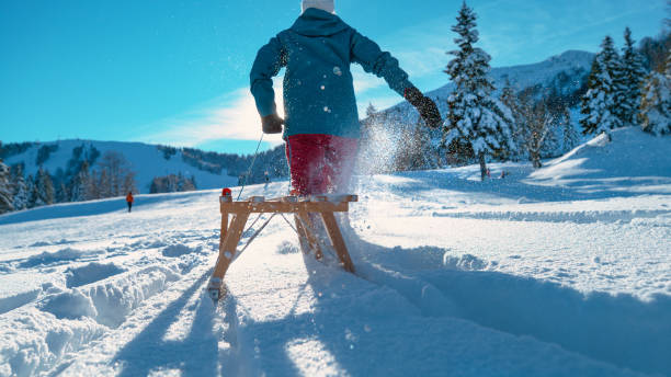 istock CLOSE UP: Unrecognizable woman drags a sled through deep snow on a sunny day. 1301180270
