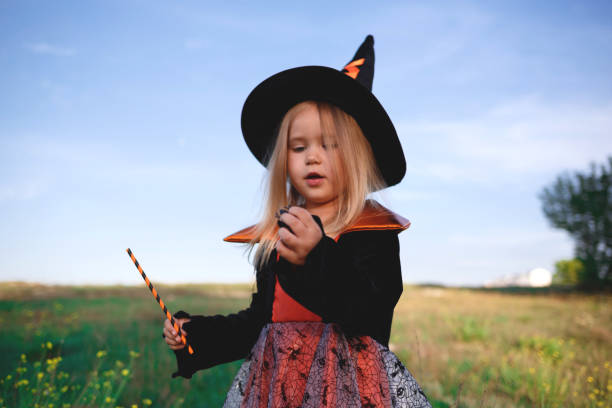 istock little girl dressed as a witch celebrates halloween 1301185909
