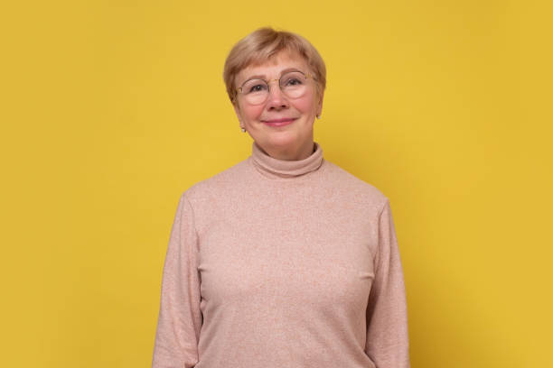 istock Aged caucasian lady with glasses posing to the camera smiling. 1301185998