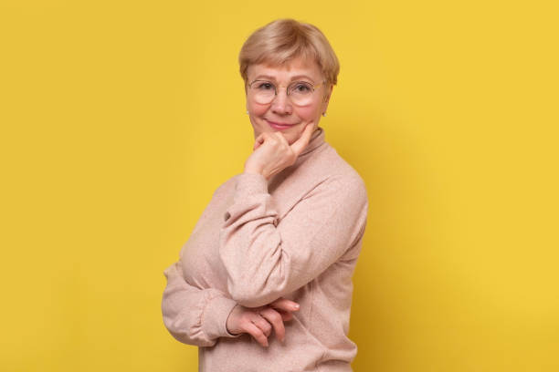 istock Aged caucasian lady with glasses posing to the camera smiling. 1301186639