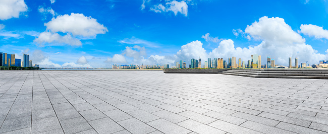 Empty square floor and modern city skyline with buildings in Hangzhou.