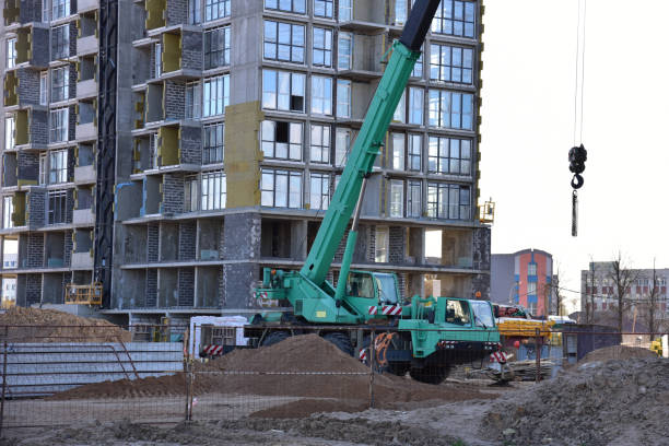 istock Mobile auto crane at construction site. Work of truck crane on project works 1301188637